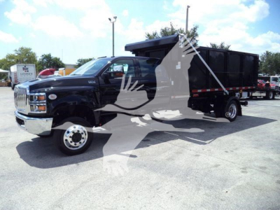 Truck in a lot showing black International CV series cab with a dump trailer, stock number CV515CREW14SNG2.