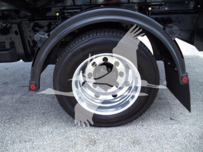 Wheel and fender area of a 2023 International CV roll-off truck showing a single rear wheel and mudguard.