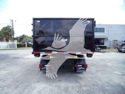 Trucking equipment rear view showing cargo box with handprint graphic and bumper with lights.