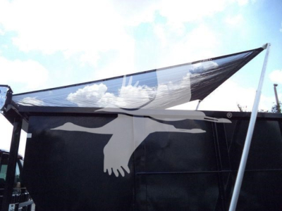 Rolloff truck body side showing black panel and protective tarp.
