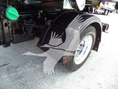 Truck rear wheel, fender and fuel filler cap visible; no legible labels or serials readable on image.