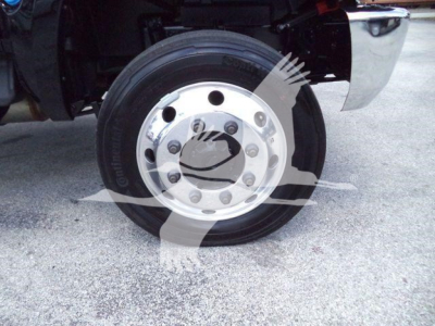 Wheel and tire assembly of a new 2023 International CV roll-off truck showing steel wheel with lug nuts and Continental tire.