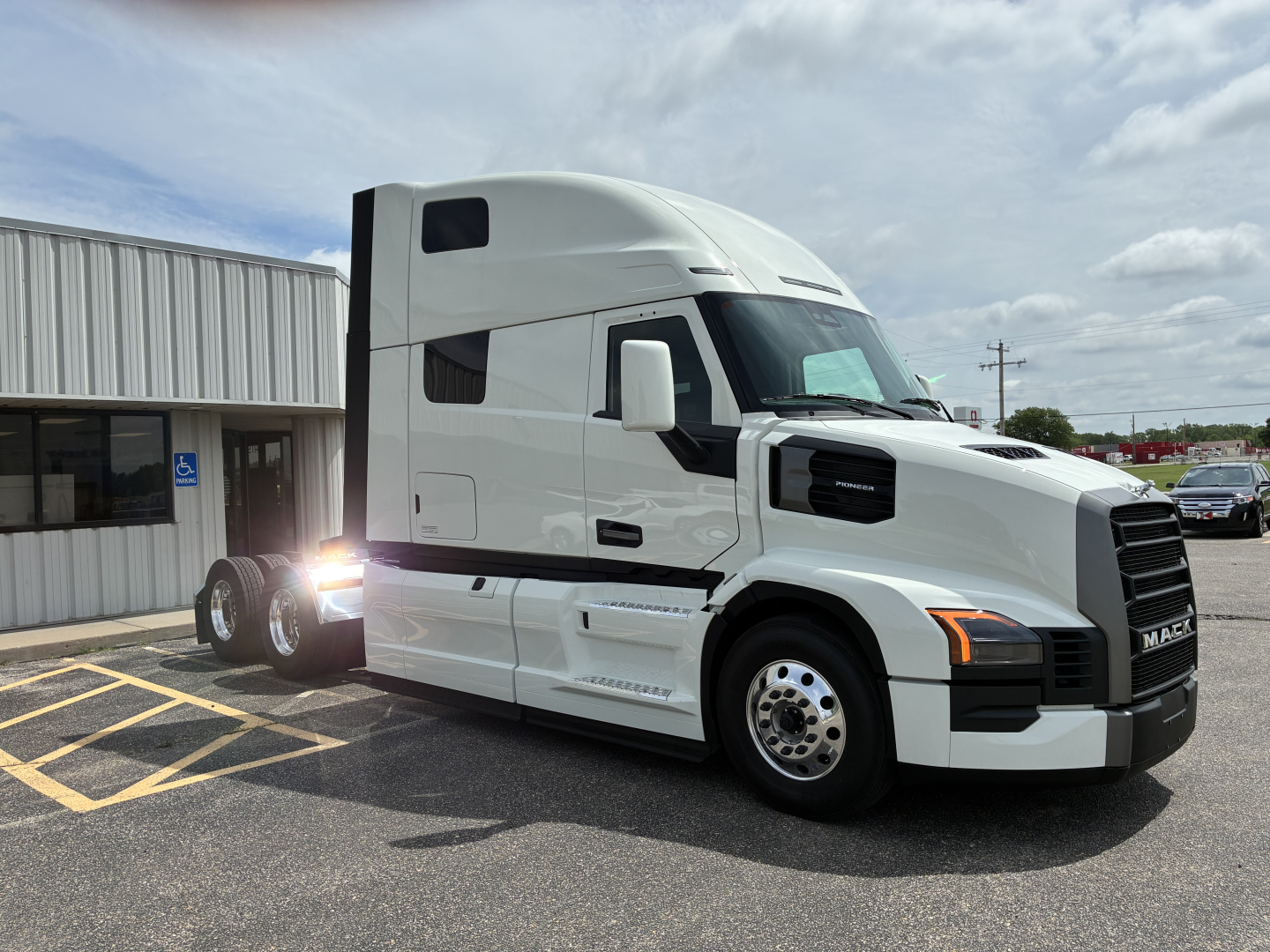 Mack PR64T76H conventional sleeper truck in white, side view, with cab and sleeper extensions, front grille and headlights visible.