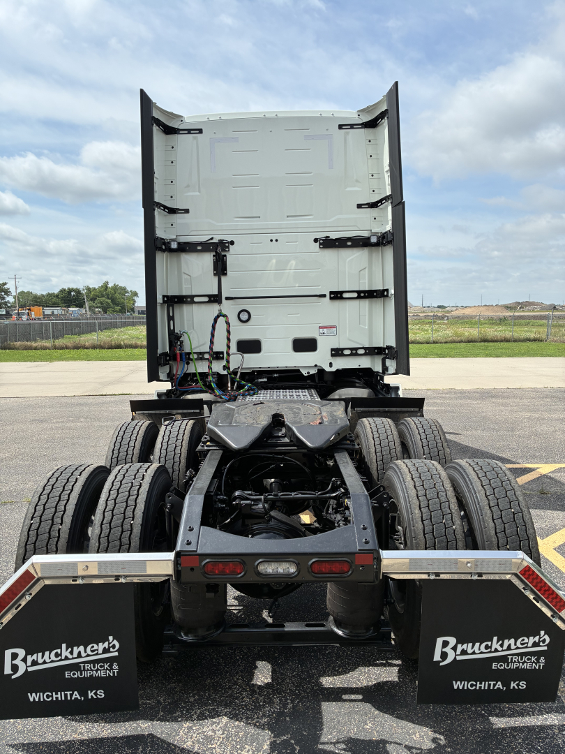 Truck tractor rear view showing fifth wheel and dual rear axles with mud flaps and Bruckner's Wichita KS branding.