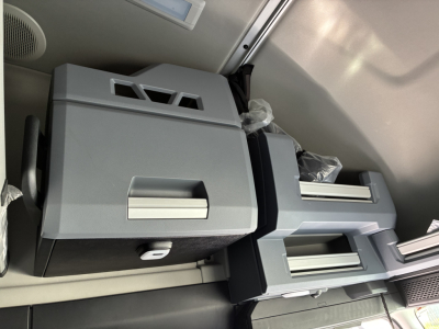 Cabinet area inside a Mack PR64T76H sleeper showing dual storage compartments and controls.