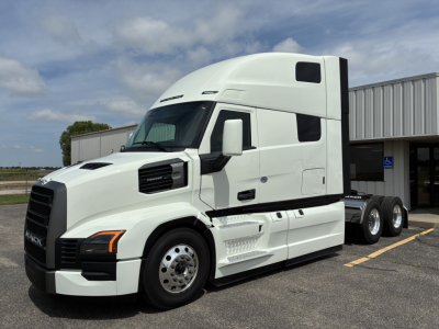 Truck image showing a white 2027 Mack PR64T76H conventional sleeper tractor; side view reveals cab, hood, dual rear axles, and wheel covers.