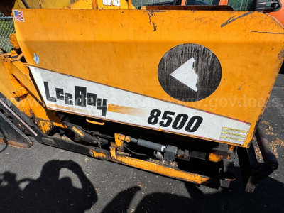 Mack asphalt paver in-service showing 8500 model number and Leeboy branding on orange body.
