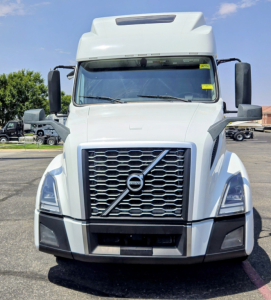 Volvo VNL64T860 truck front view showing grille with Volvo emblem, large windshield, and side mirrors.