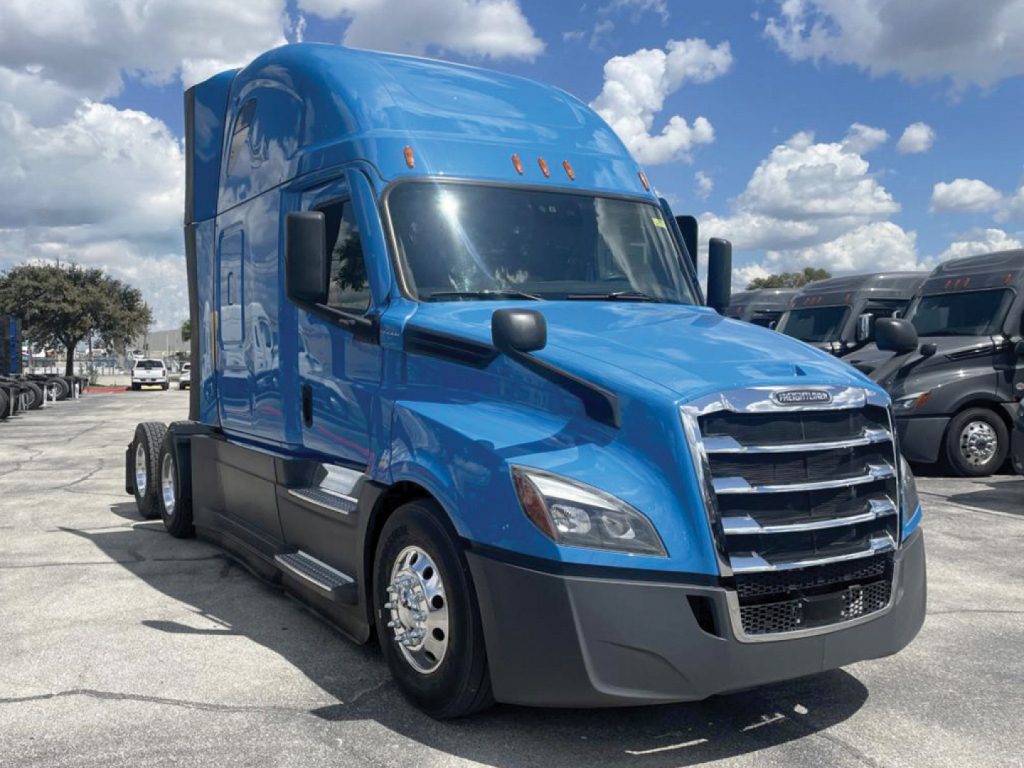 Blue Freightliner Cascadia 126 tractor-truck cab front-left view with sleeper, chrome wheels, and black bumper.