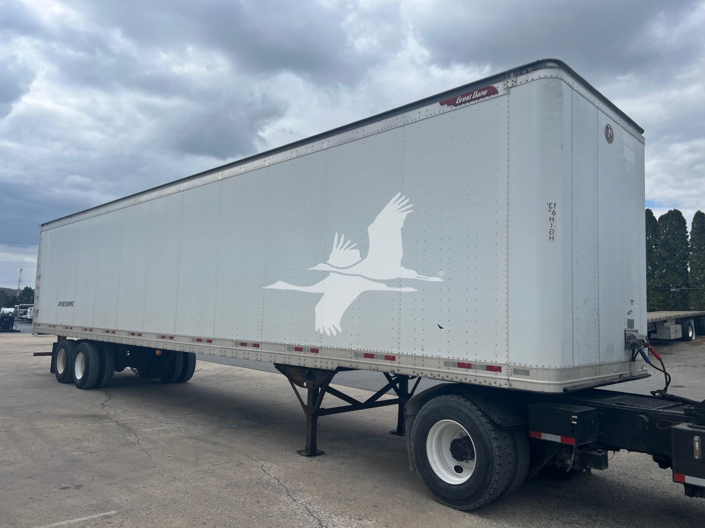 Great Dane sheet and post roll door trailer showing side profile with white exterior and dove graphic.