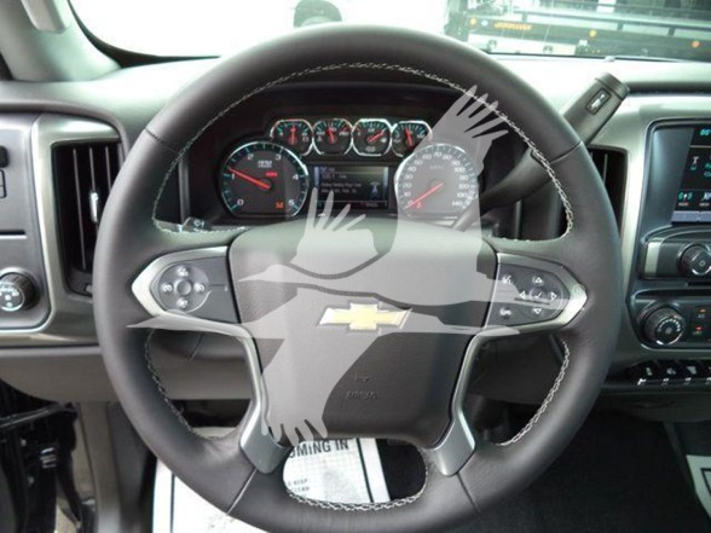 Dashboard and steering wheel of a Chevrolet Silverado 6500HD interior view.