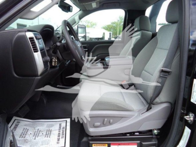 Interior of a 2023 Chevrolet Silverado 6500HD crew cab showing front seats, dashboard, and steering wheel.