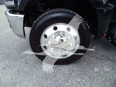 Front wheel and tire of a 2023 Chevrolet Silverado 6500HD rollback truck showing steel wheel and tire details.