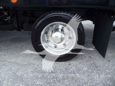 Wheel and hub of a 2023 Chevrolet Silverado 6500HD rollback truck showing polished steel hubcap and black tire.