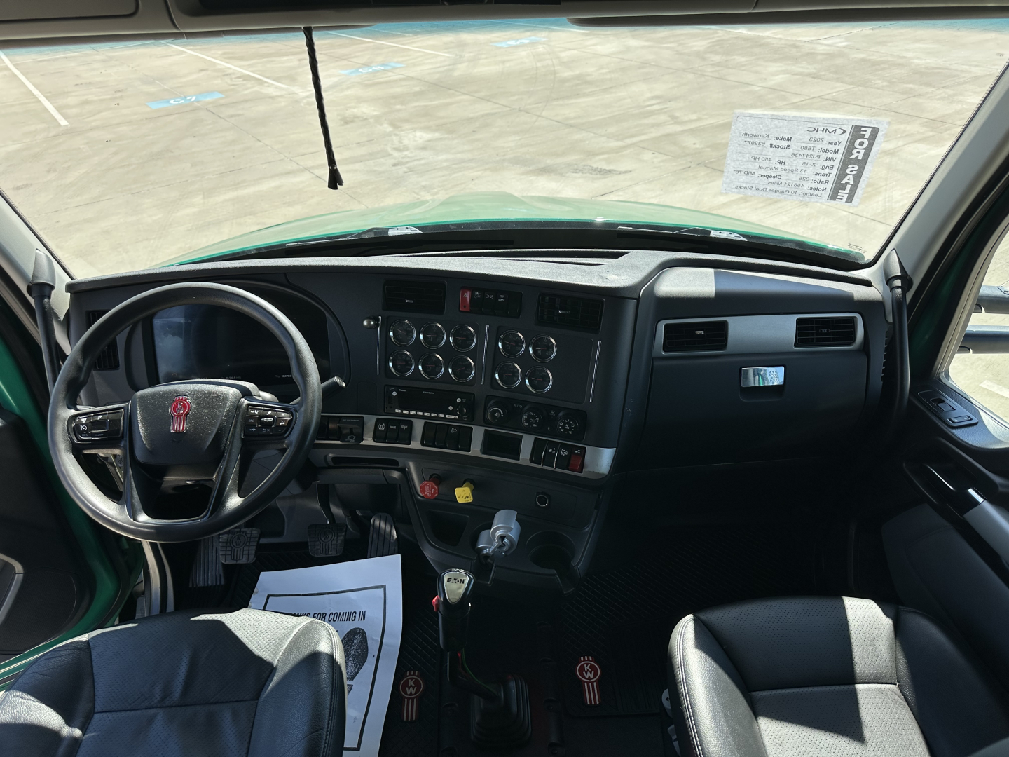 Kenworth T680 truck cab interior dash and steering wheel with controls and gauges visible.