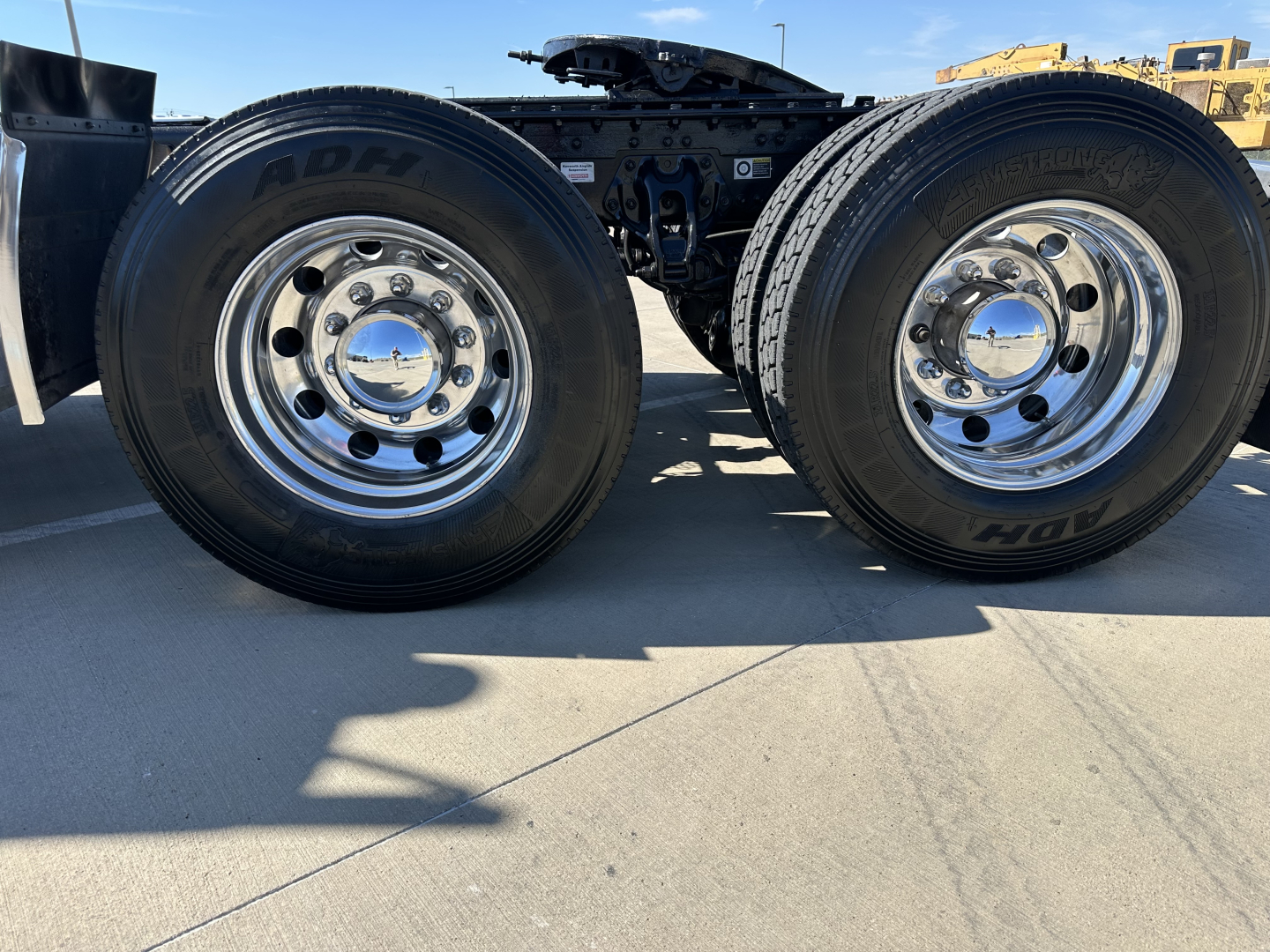 Kenworth T680 truck chassis with dual rear wheels showing chrome wheel hubs and tires.