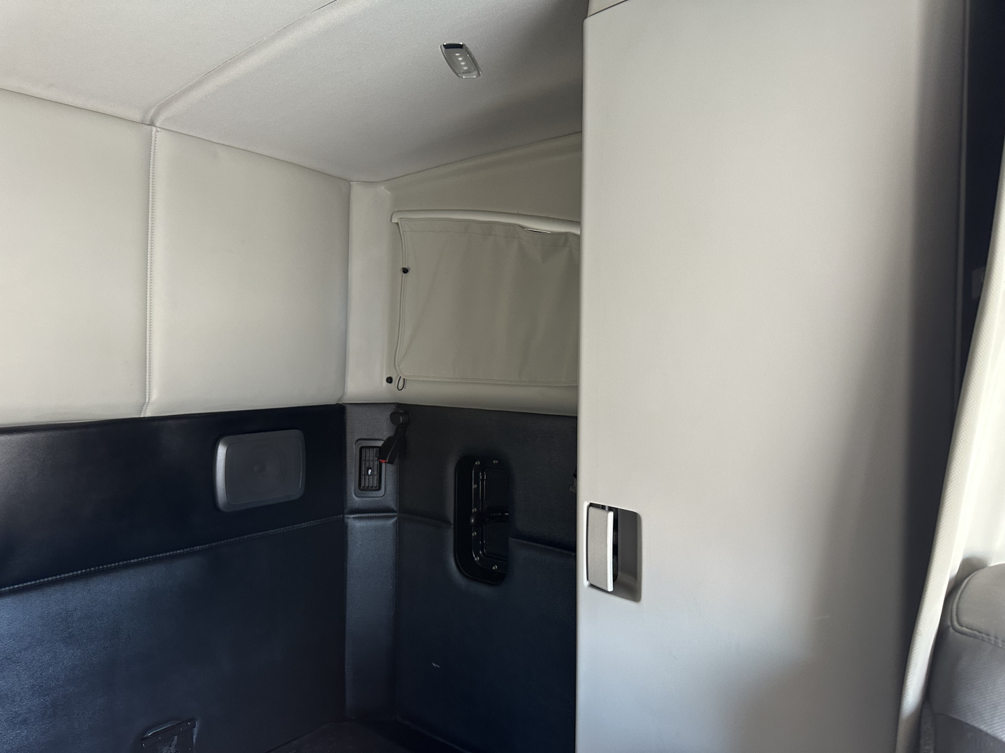 Kenworth T680 sleeper cab interior showing door panel and storage area