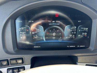 Kenworth T680 dashboard display showing digital instrument cluster with speedometer, fuel, temperature gauges; Park brake icon visible.