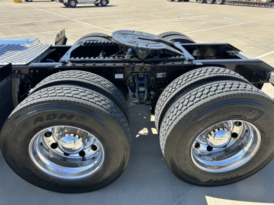 Kenworth T680 chassis view showing dual rear axles with chrome wheels and tire details.
