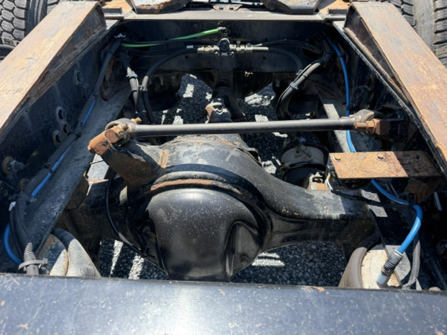 Truck chassis with rear drive axle and suspension visible. No legible text visible on components in image.