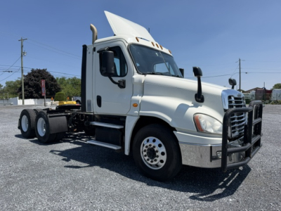 Truck showing front-right view of a 2017 Freightliner Cascadia CA125DC with chrome bumper guard, dual rear axle, and white cab.