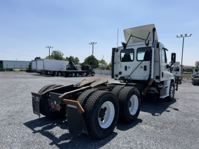 Truck chassis with rear dual-axle configuration in a lot; cab with bunk area; no visible fuel or coolant labels readable from this angle.