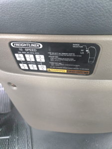 Freightliner dashboard label showing 10 speed shift pattern and range selector diagram for a Cascadia single axle truck.