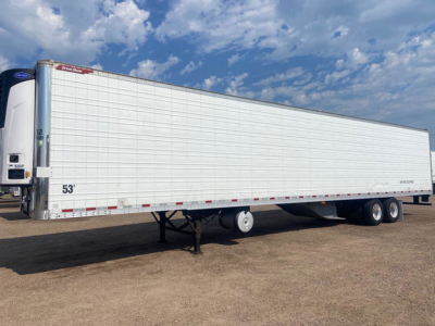Great Dane reefer trailer in side view with white insulated panels, 53' length, tandem axles at rear, hanging landing gear, refrigeration unit at front.