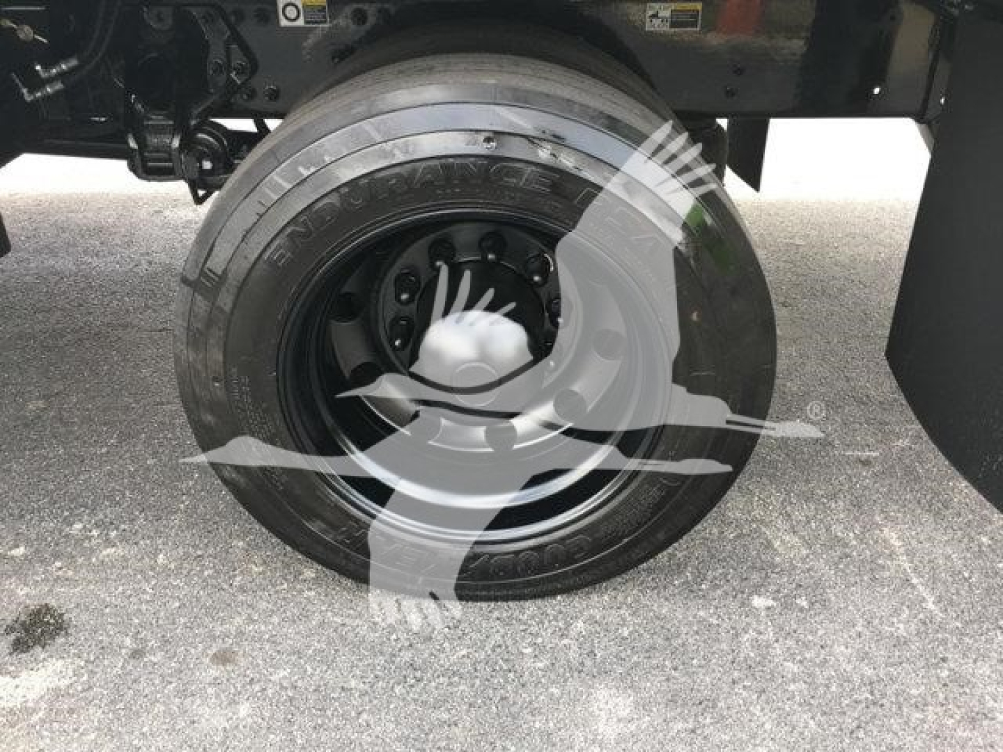 Peterbilt 337 rollback truck wheel and tire visible with stock number J99287; no other text legible.