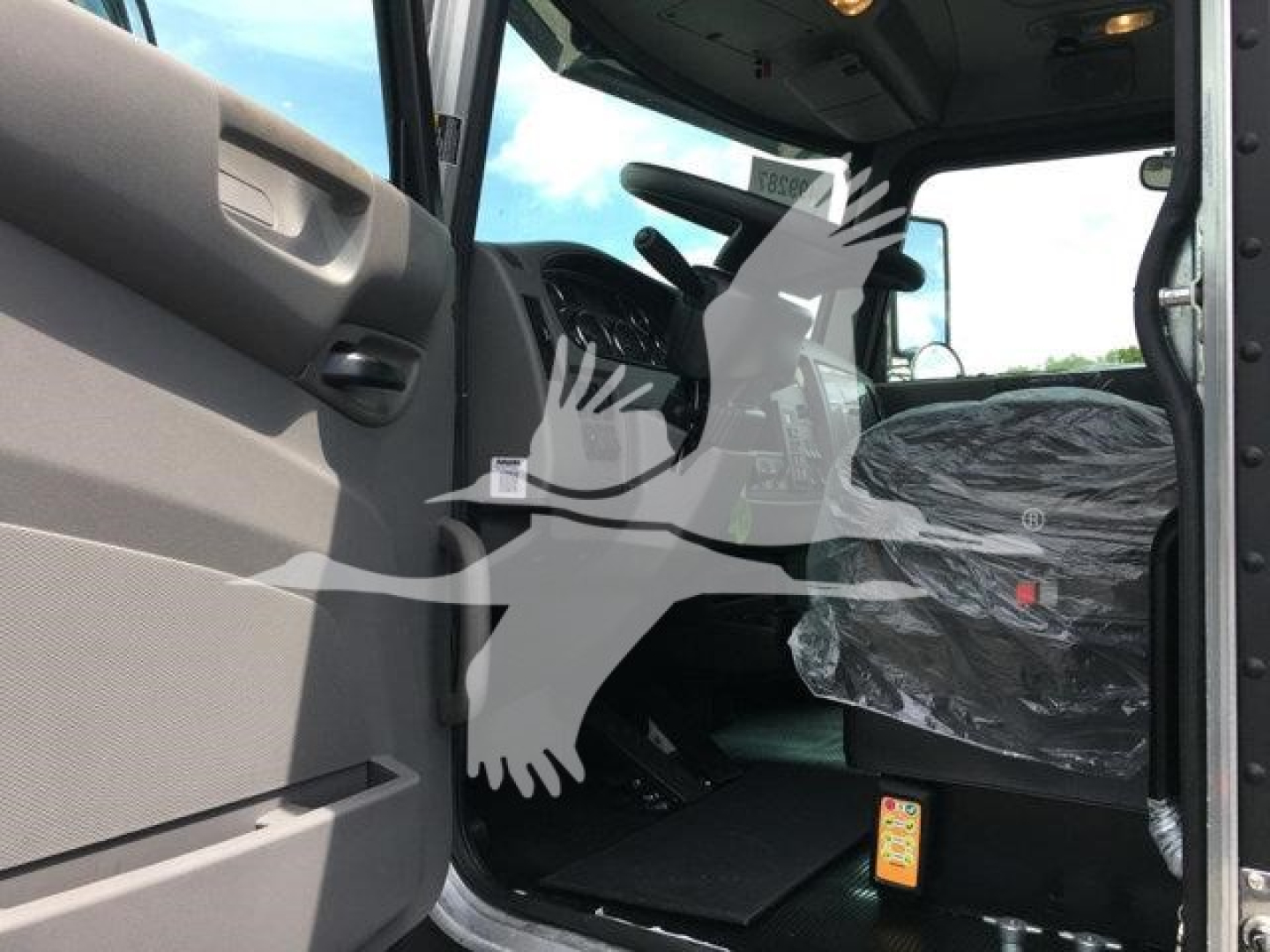 Peterbilt 337 truck cabin interior view showing seating area and controls.