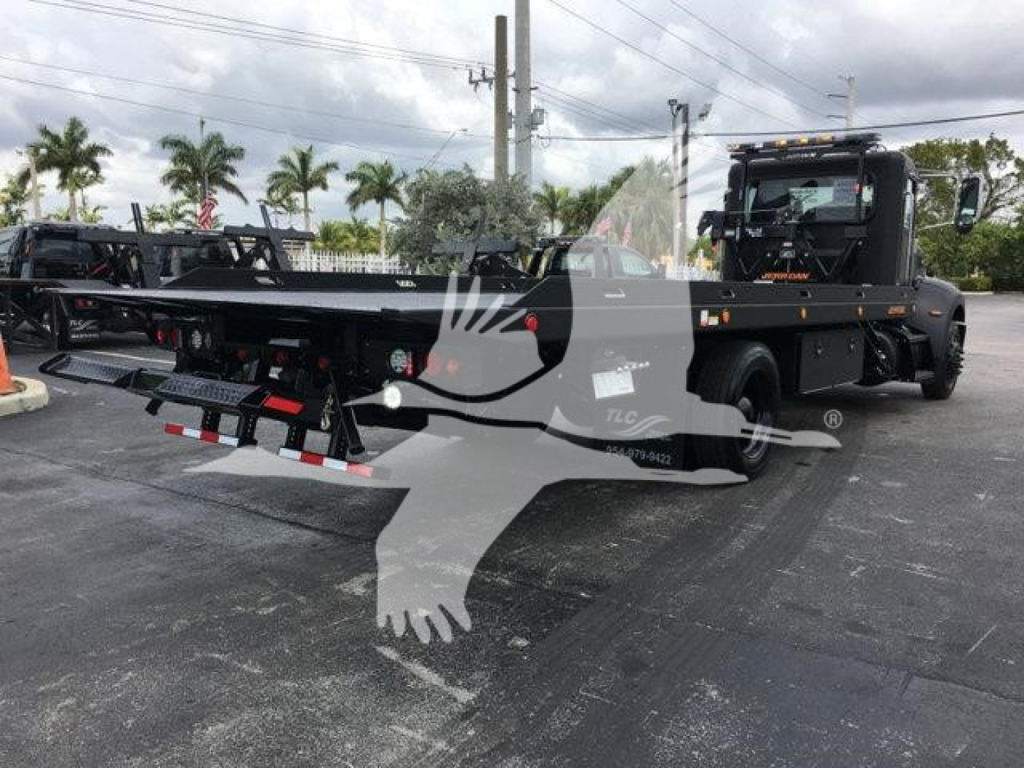 Peterbilt 337 rollback truck with flatbed trailer in a dealership lot; visible text includes Stock Number J99287 and category/type details in listing context.