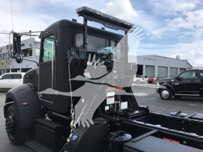 Truck cab of a 2022 Peterbilt 337 rollback unit with stock number J99287 visible on the cab door area.