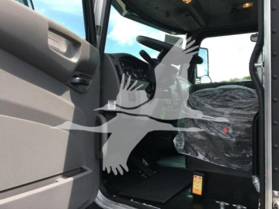 Peterbilt 337 truck cabin interior view showing seating area and controls.
