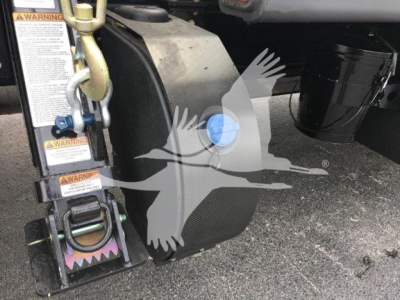 Peterbilt 337 rollback truck hitch area with warning labels and blue service cap.