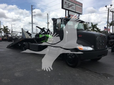 Peterbilt 337 rollback truck in black with equipment attached, SMART Overlay watermark across image. Visible text on sign: TLC Collision Center. The truck has a large front grille and dual headlights.