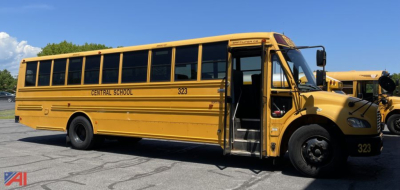 School bus side view showing yellow 2014 Freightliner C2 bus with open front door, Central School 323 lettering, and black wheels.