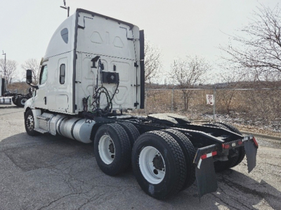 Freightliner Cascadia126 sleeper tractor rear view showing chassis and dual rear axles with mud flaps and coupling area.