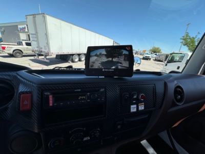 Cab interior of a 2024 Hino L7 showing dashboard with mounted display and instrument cluster