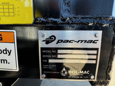 PAC-MAC plate on Hino L7 grapple truck showing model/serial/VIN fields and Hol-Mac logo.