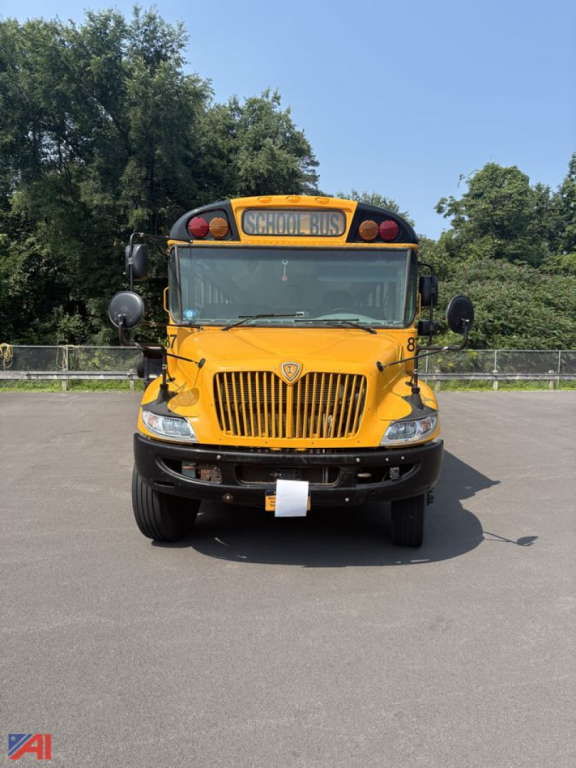 Front view of a yellow 2021 IC Corporation CE Series school bus with a prominent grille and School Bus sign, parked on a paved lot.