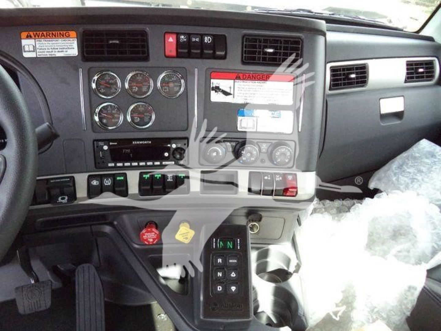 Kenworth T880 dashboard and center console with gauges, controls, and gear selector visible.