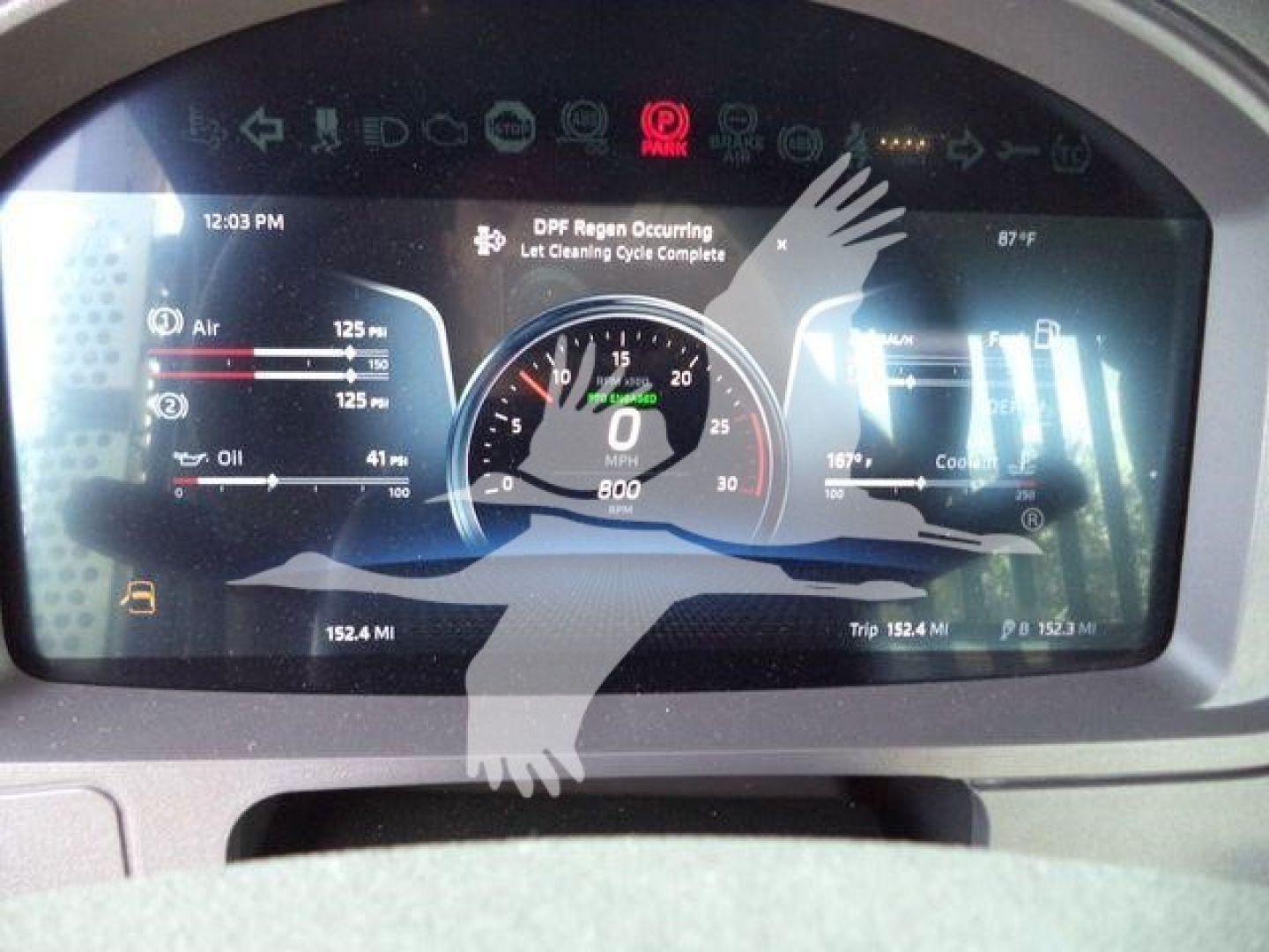 Dashboard display of a 2026 Kenworth T880 showing virtual gauges and warnings on a widescreen monitor.