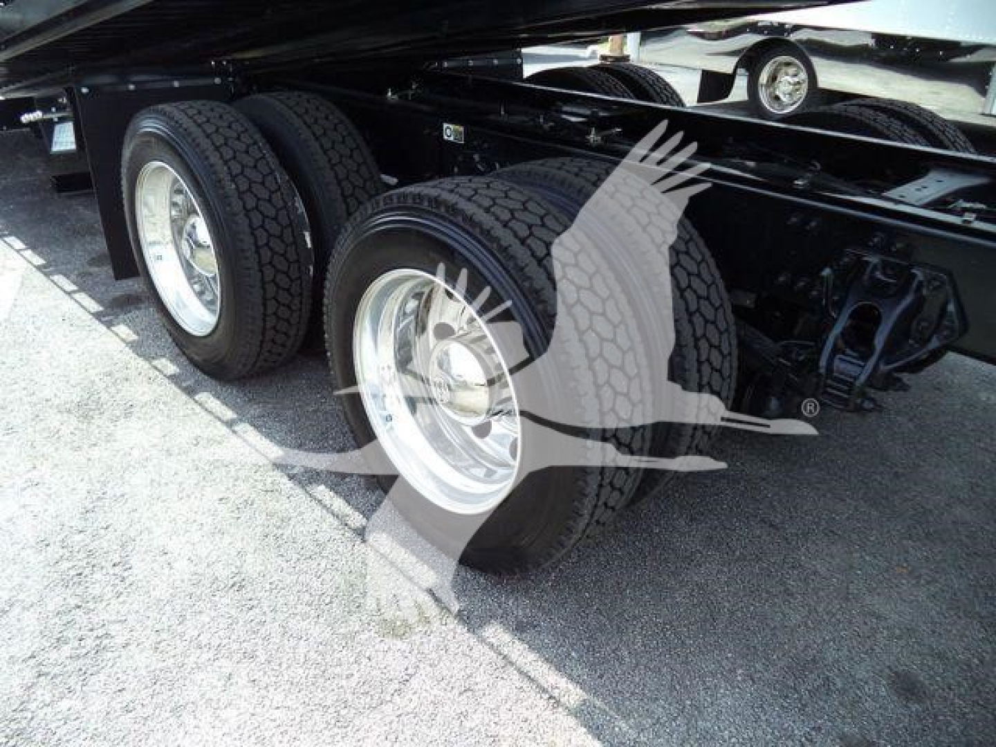 Kenworth T880 suspension/axles showing dual rear axles and wheel tires side view.