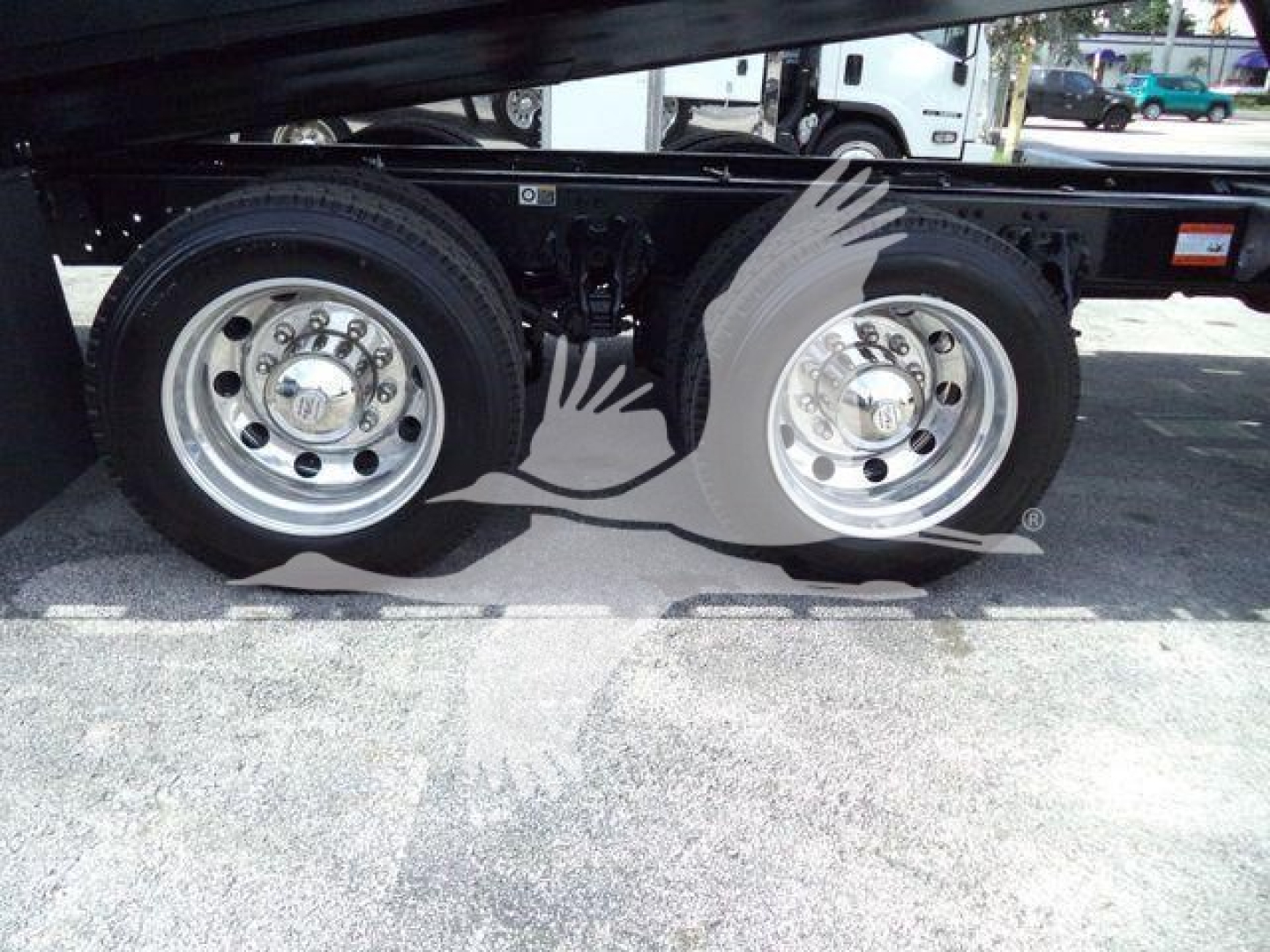 Kenworth T880 roll-back truck dual rear wheels showing chrome wheels and suspension area.