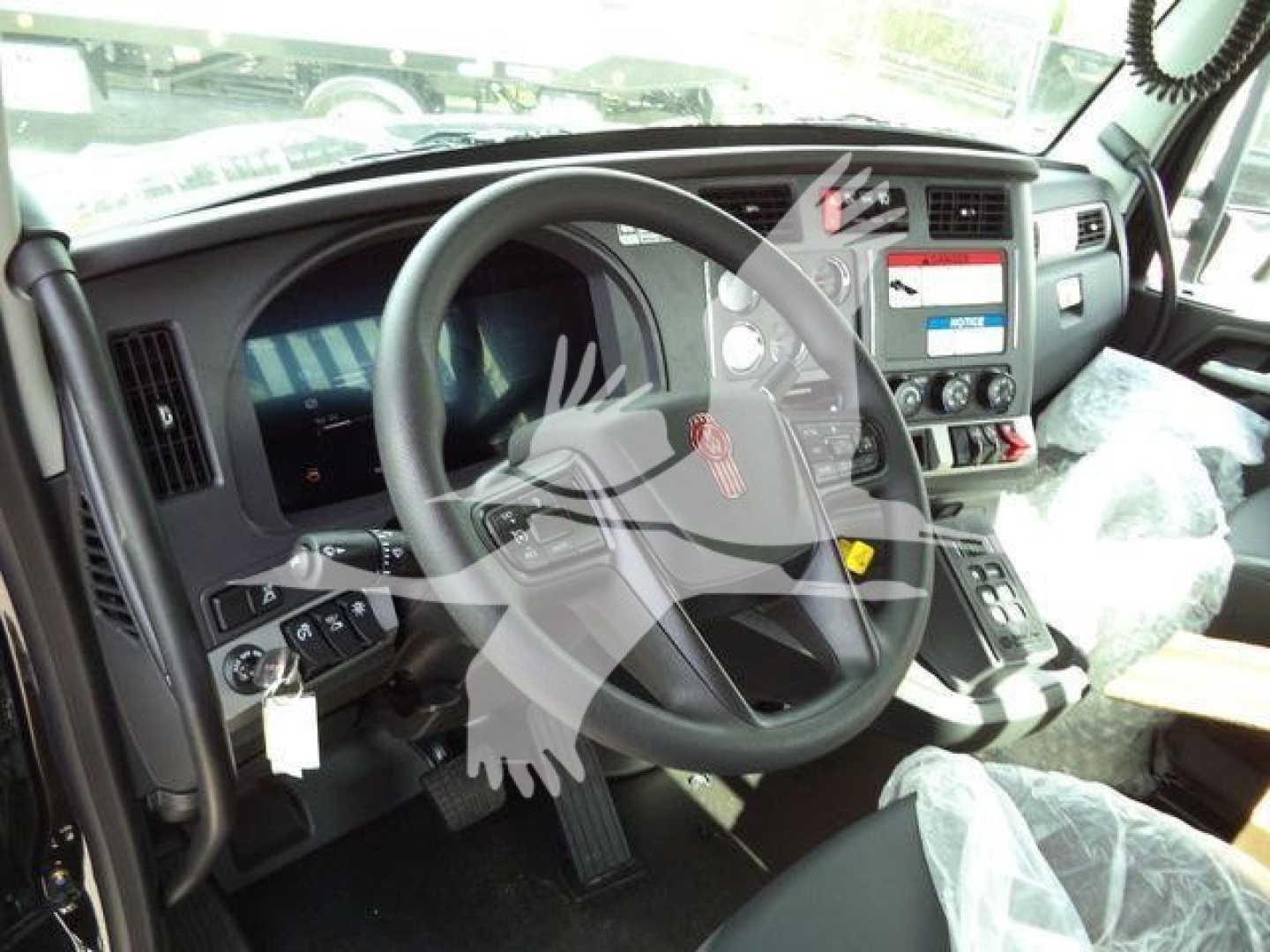 Kenworth T880 truck interior driver seat and dashboard with steering wheel and controls visible