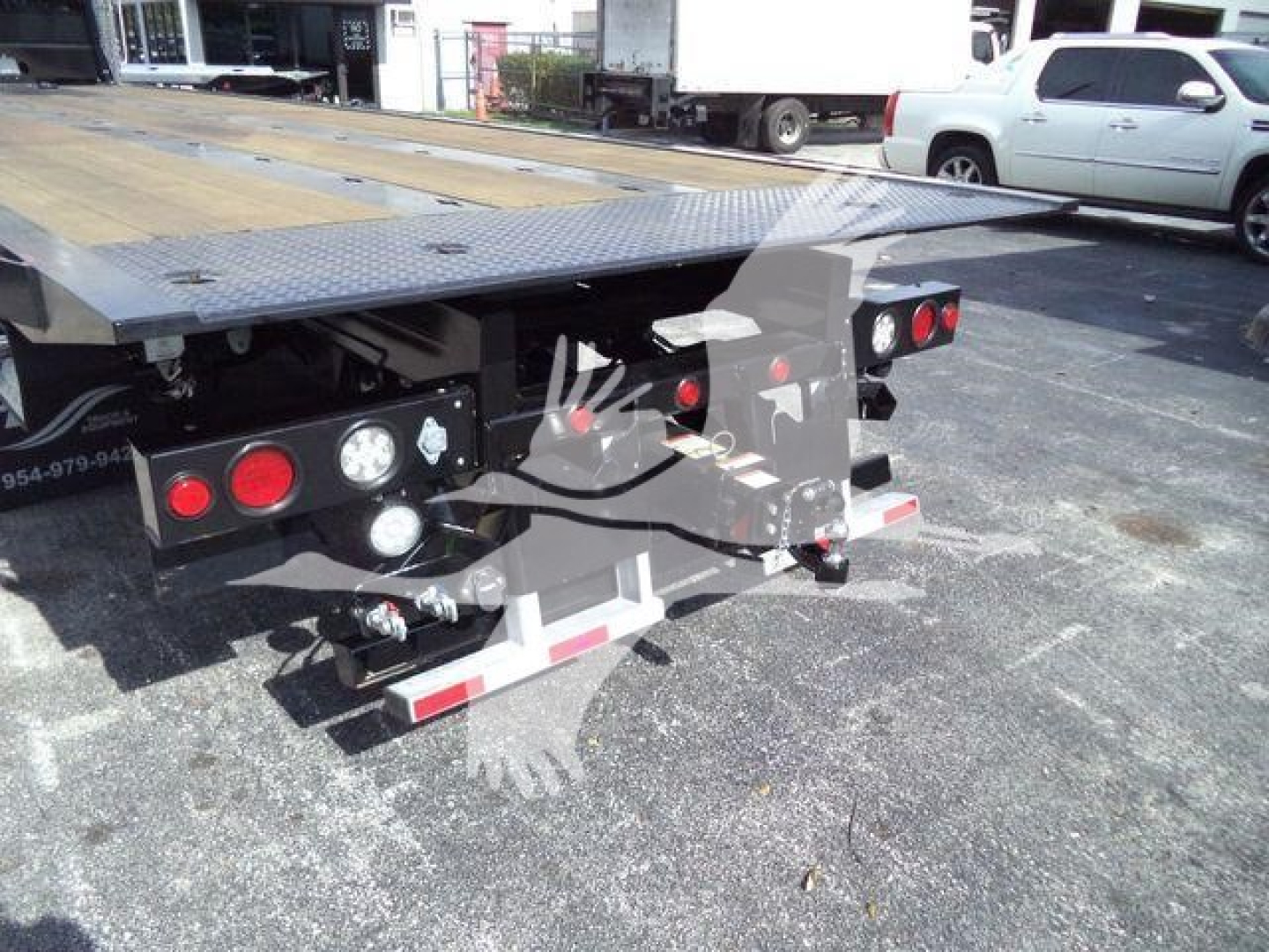 Kenworth T880 rollback bed rear view showing platform and rear light clusters with chrome bumper guards.