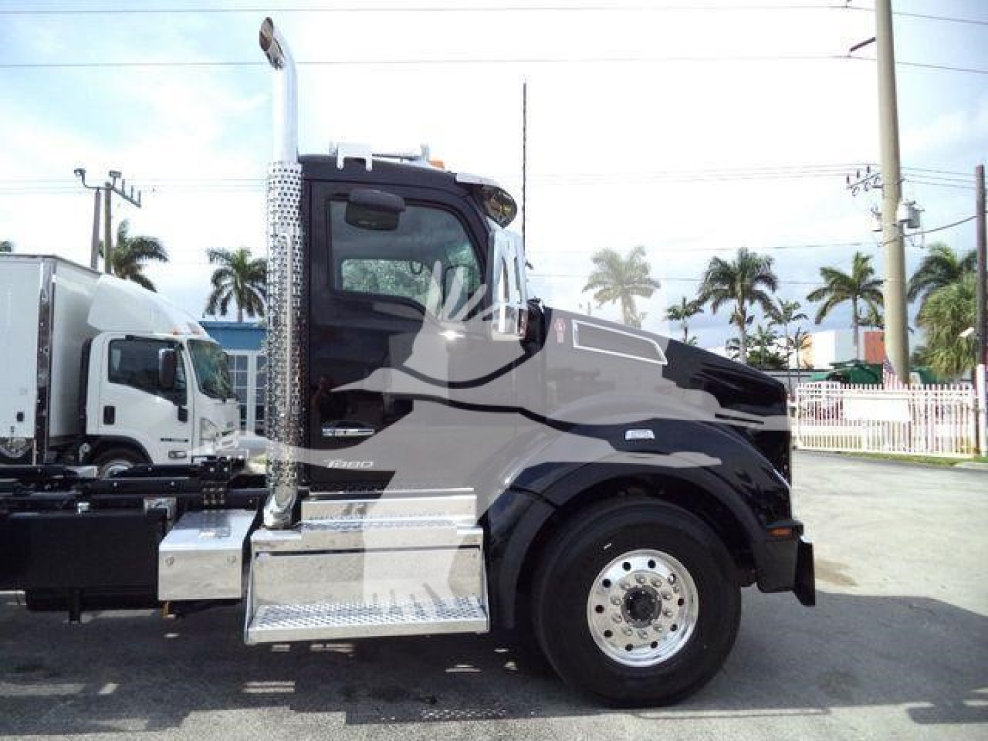 Kenworth T880 rollback truck side profile showing cab and fuel/step area with chrome exhaust stack and wheel.