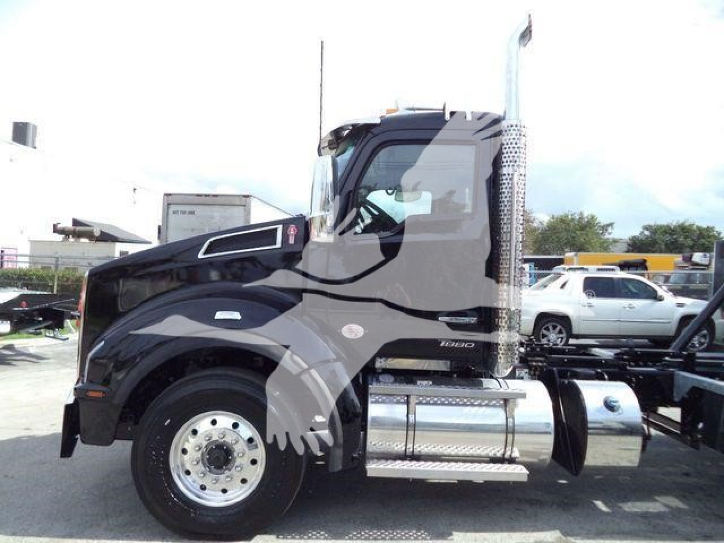 Kenworth T880 rollout truck side view showing cab, chrome fuel tanks, steps, and exhaust stack with 6-rod mirrors.