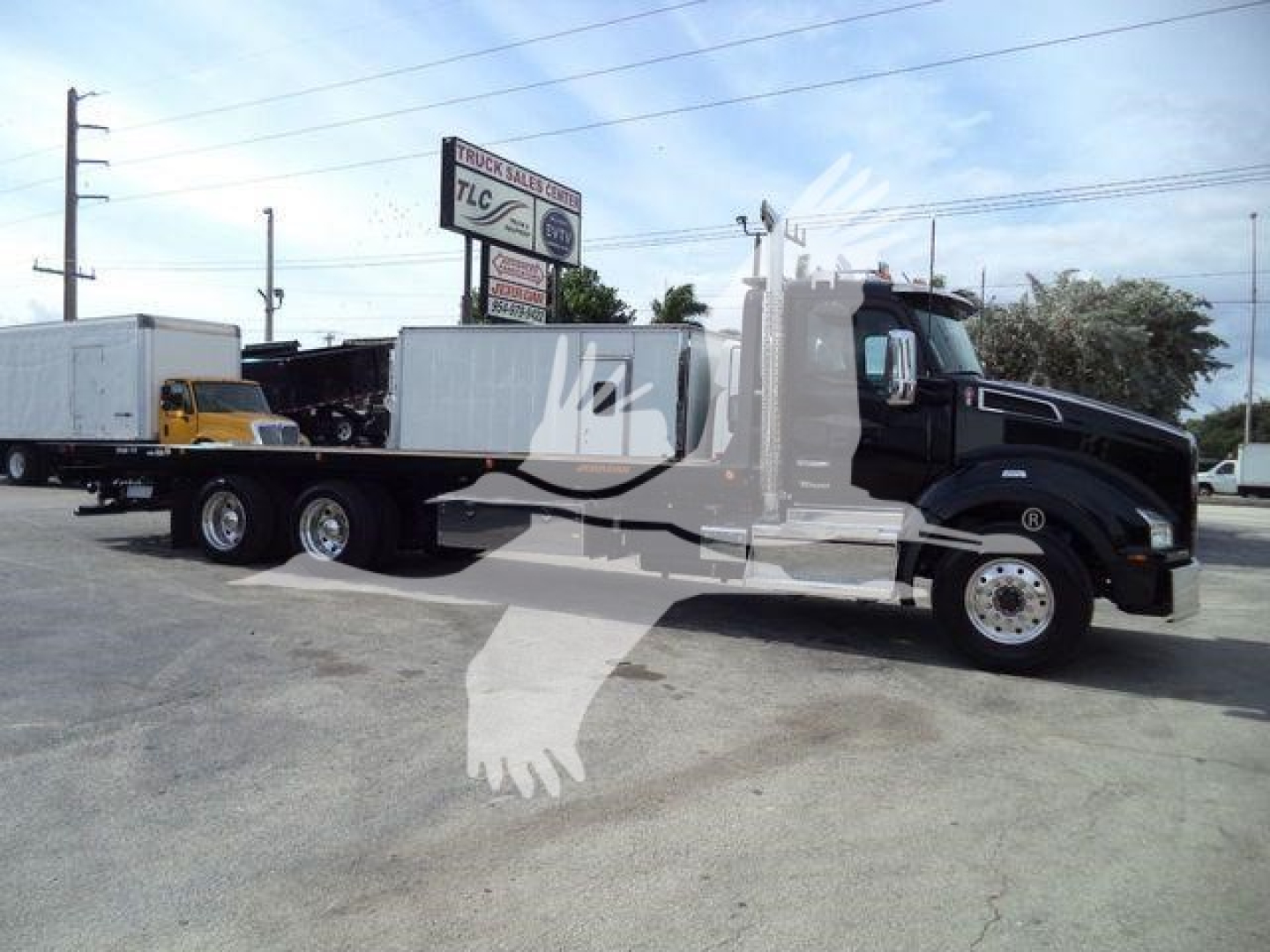 Kenworth T880 rollback truck in side view showing long flatbed with trailer and cab, black color, stock number KWT880HD15T visible.