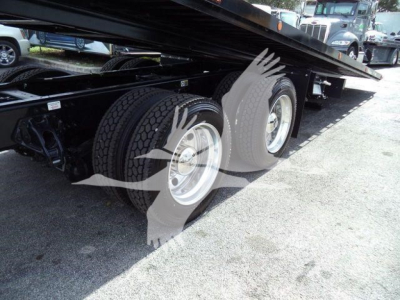 Kenworth T880 rollback heavy duty trailer showing dual rear axles and underside components.